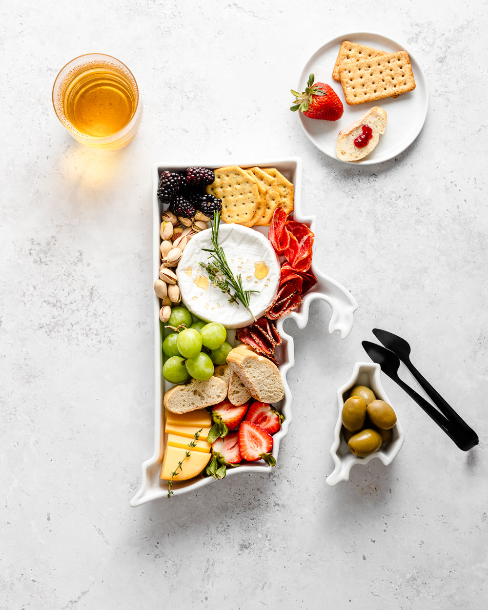 charcuterie board with cheese and cured meats in a Rhode Island shaped serving tray platter dish