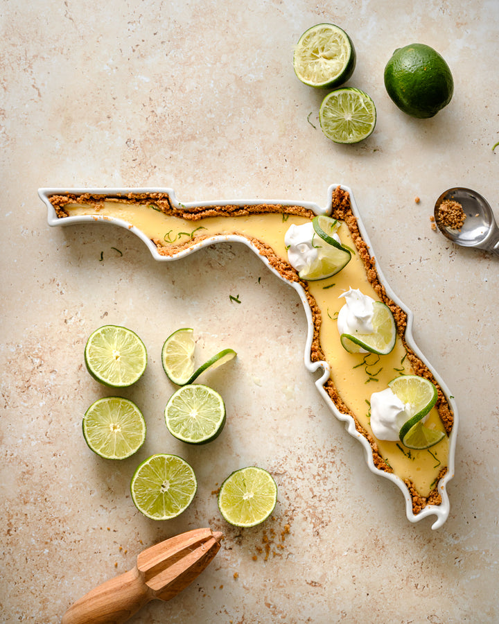 Florida State Plate shown with a dessert, key lime pie. The FL State Plate can be used for food in the oven. Florida dessert dish. Florida pie dish. Florida serving dish. FL ceramic dish. Florida gift.
