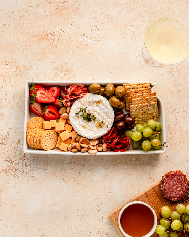charcuterie board with cheese and cured meats in a Kansas shaped serving tray platter dish