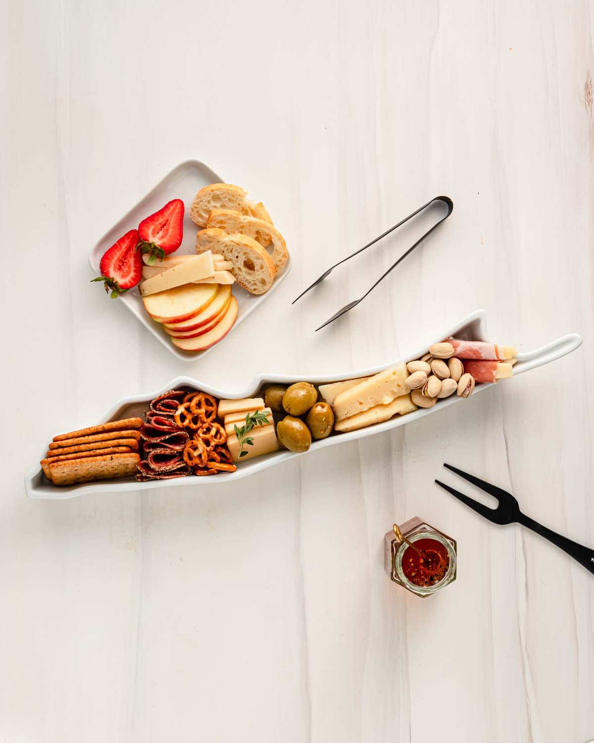 charcuterie board with cheese and cured meats in a Long Island shaped serving tray platter dish