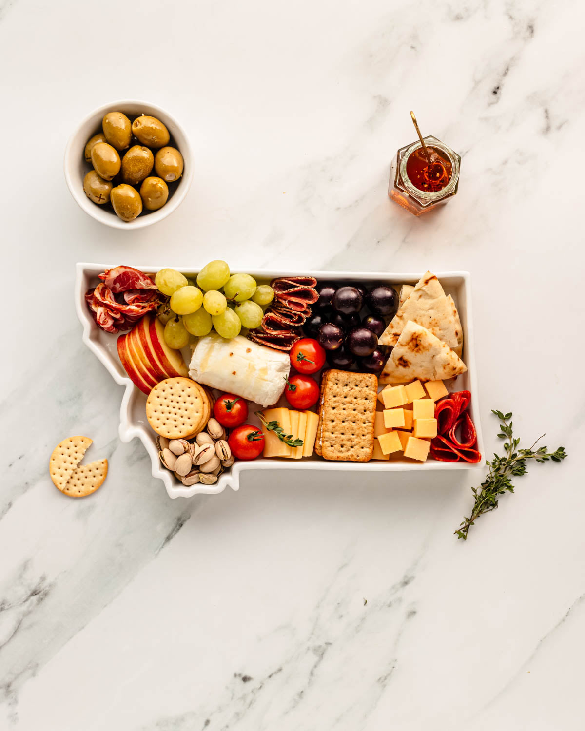 charcuterie board with cheese and cured meats in a Montana shaped serving tray platter dish