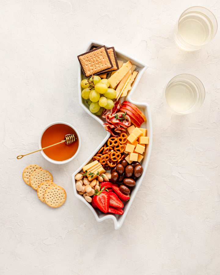 charcuterie board with cheese and cured meats in a New Jersey shaped serving tray platter dish