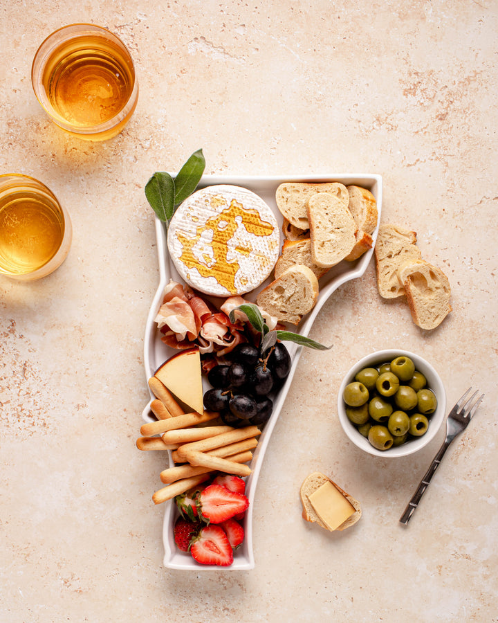 charcuterie board with cheese and cured meats in a Vermont shaped serving tray platter dish