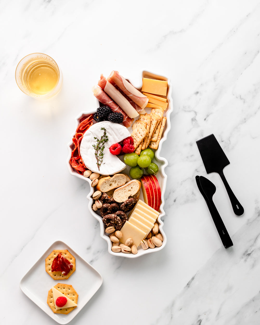 charcuterie board with cheese and cured meats in a Lake Tahoe shaped serving tray platter dish