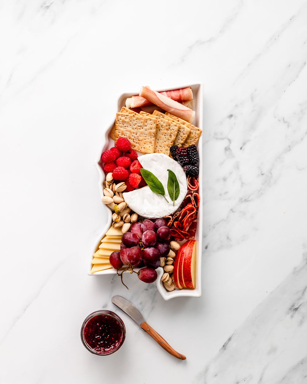 charcuterie board with cheese and cured meats in a Mississippi shaped serving tray platter dish