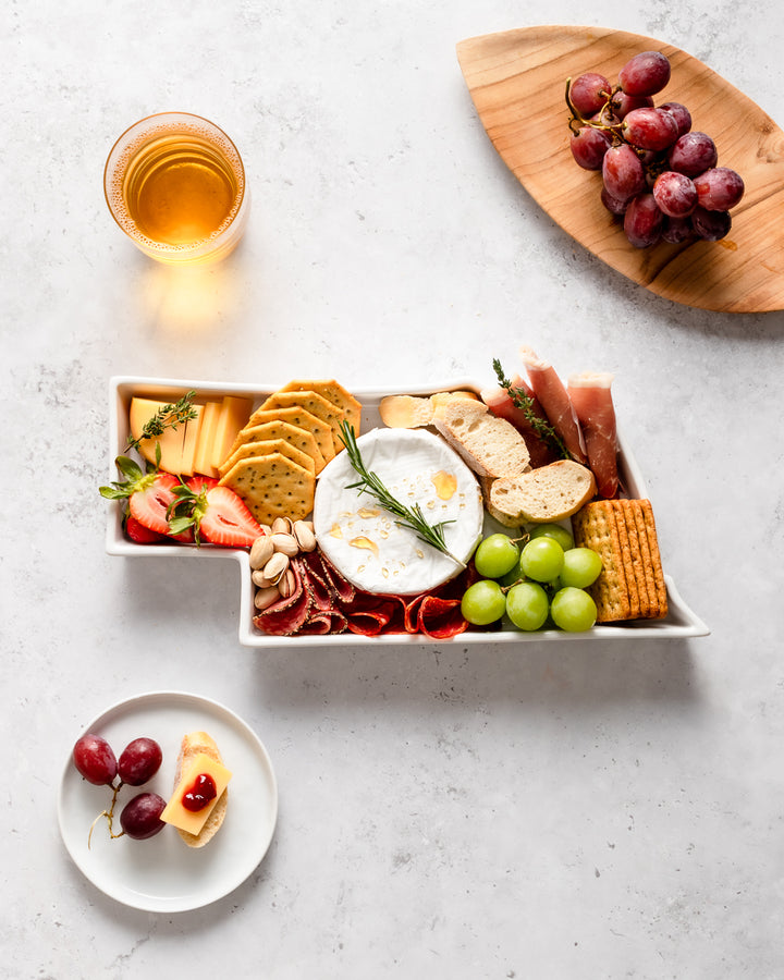 charcuterie board with cheese and cured meats in a Nebraska shaped serving tray platter dish