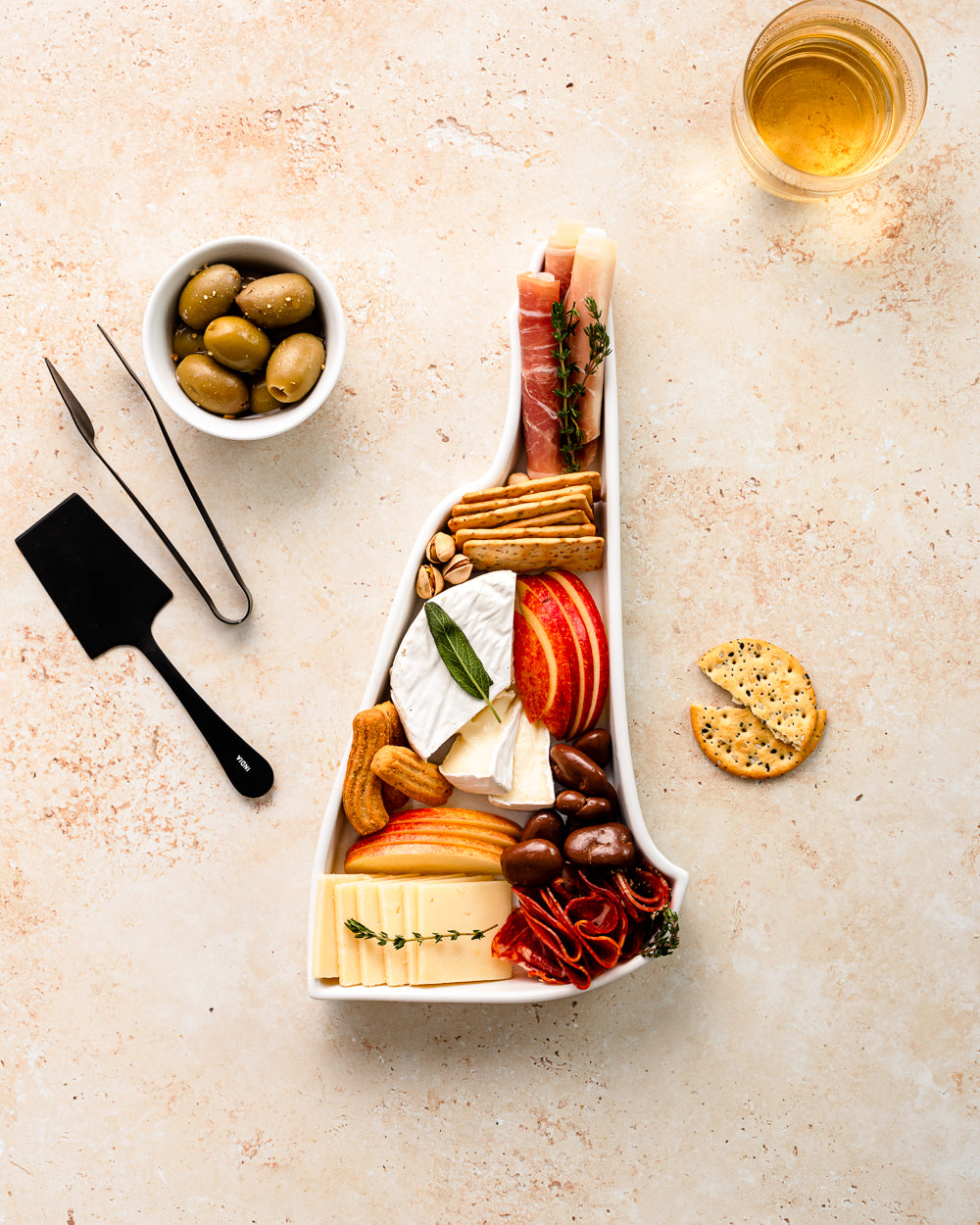 charcuterie board with cheese and cured meats in a New Hampshire shaped serving tray platter dish