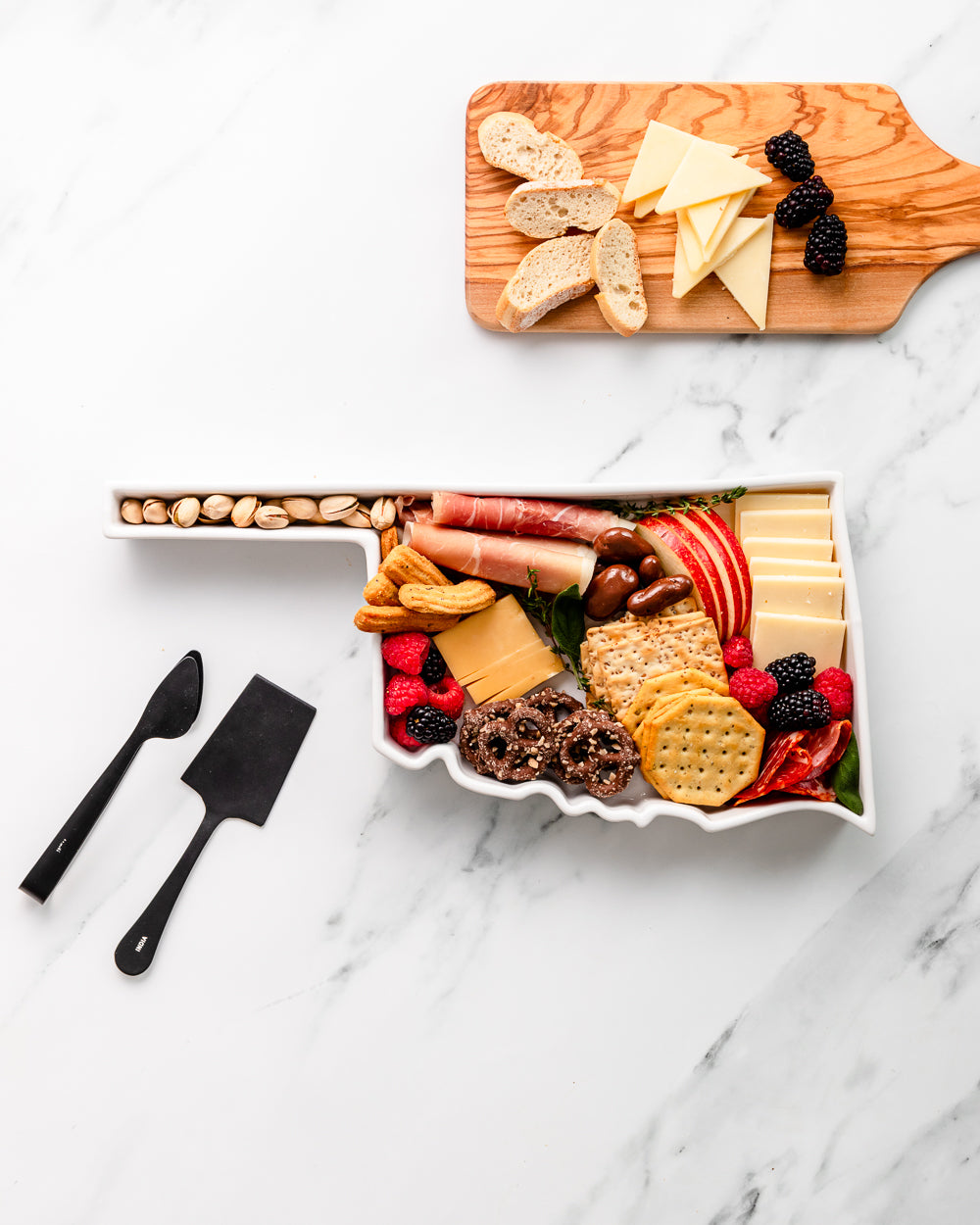charcuterie board with cheese and cured meats in a Oklahoma shaped serving tray platter dish
