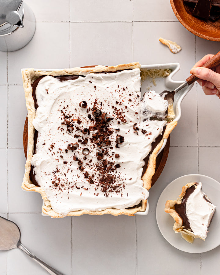 chocolate and cream pie in a white pie dish shaped like Arkansas