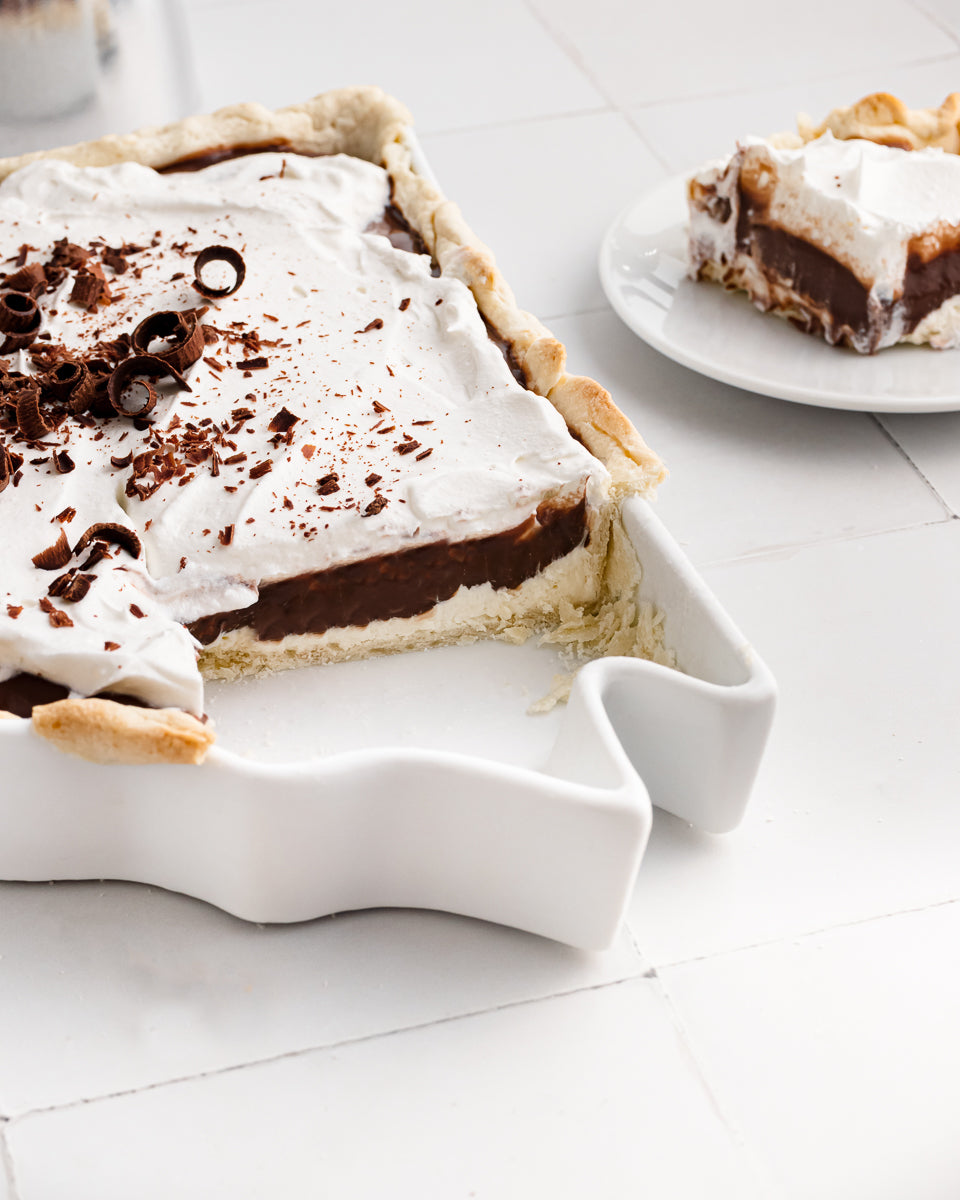 detail shot of chocolate and cream pie in a white pie dish shaped like Arkansas