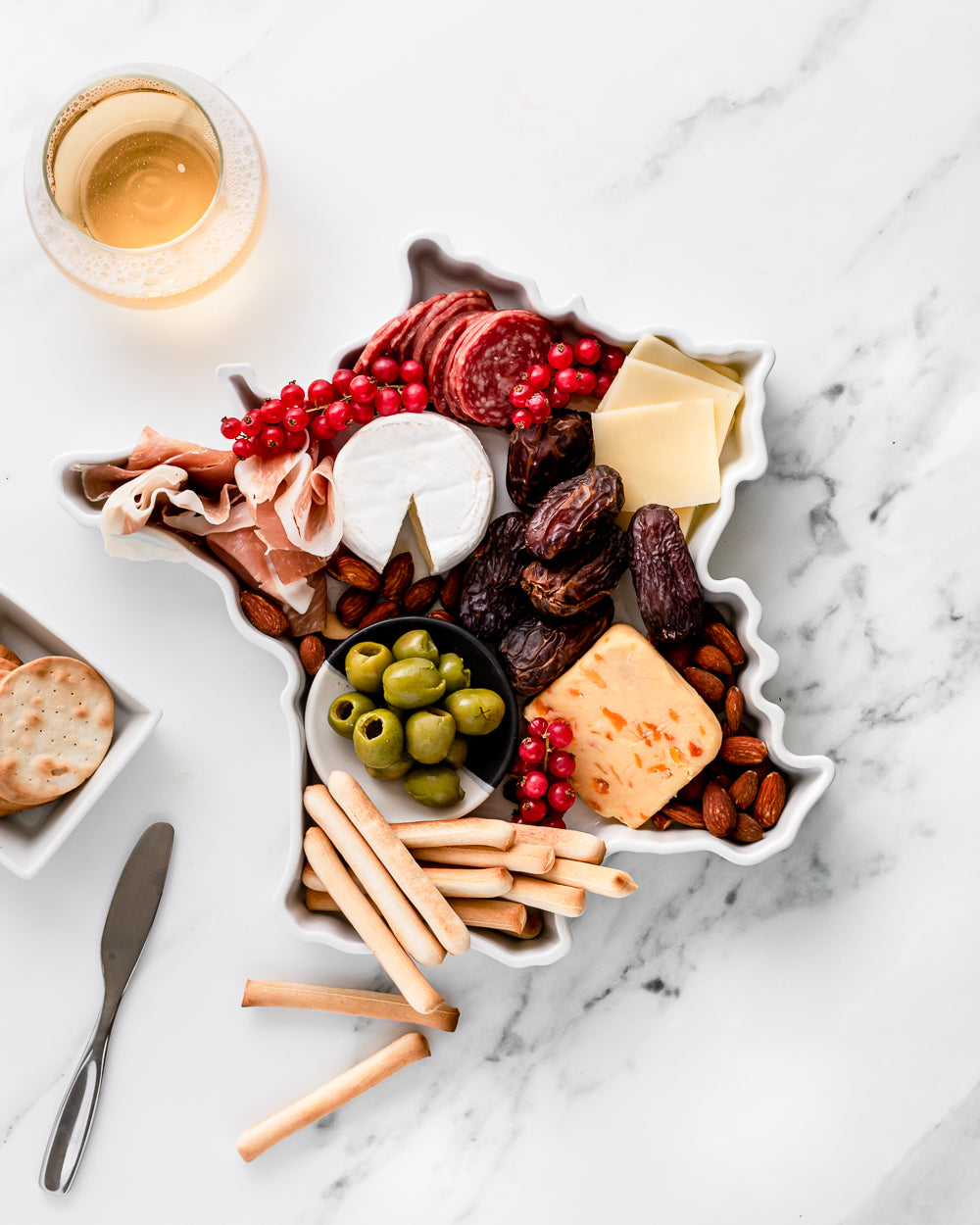 charcuterie board with cheese and cured meats in a france shaped serving tray platter dish