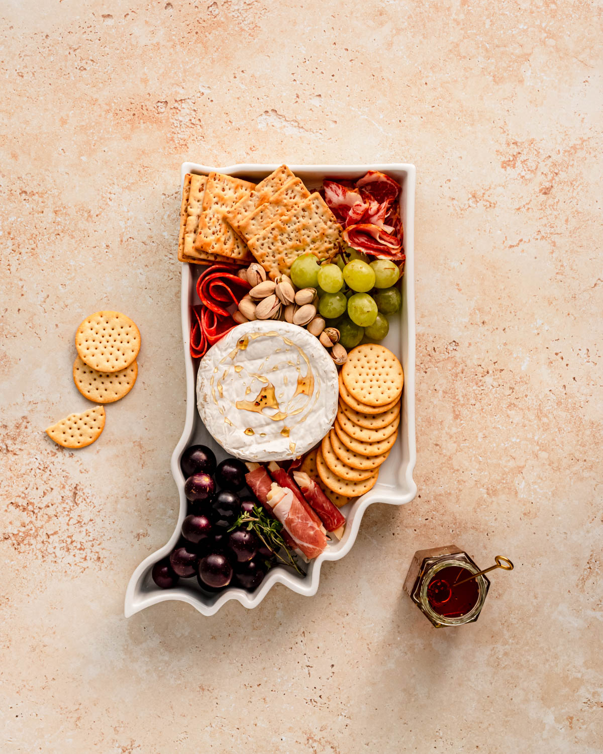 charcuterie board with cheese and cured meats in a Indiana shaped serving tray platter dish