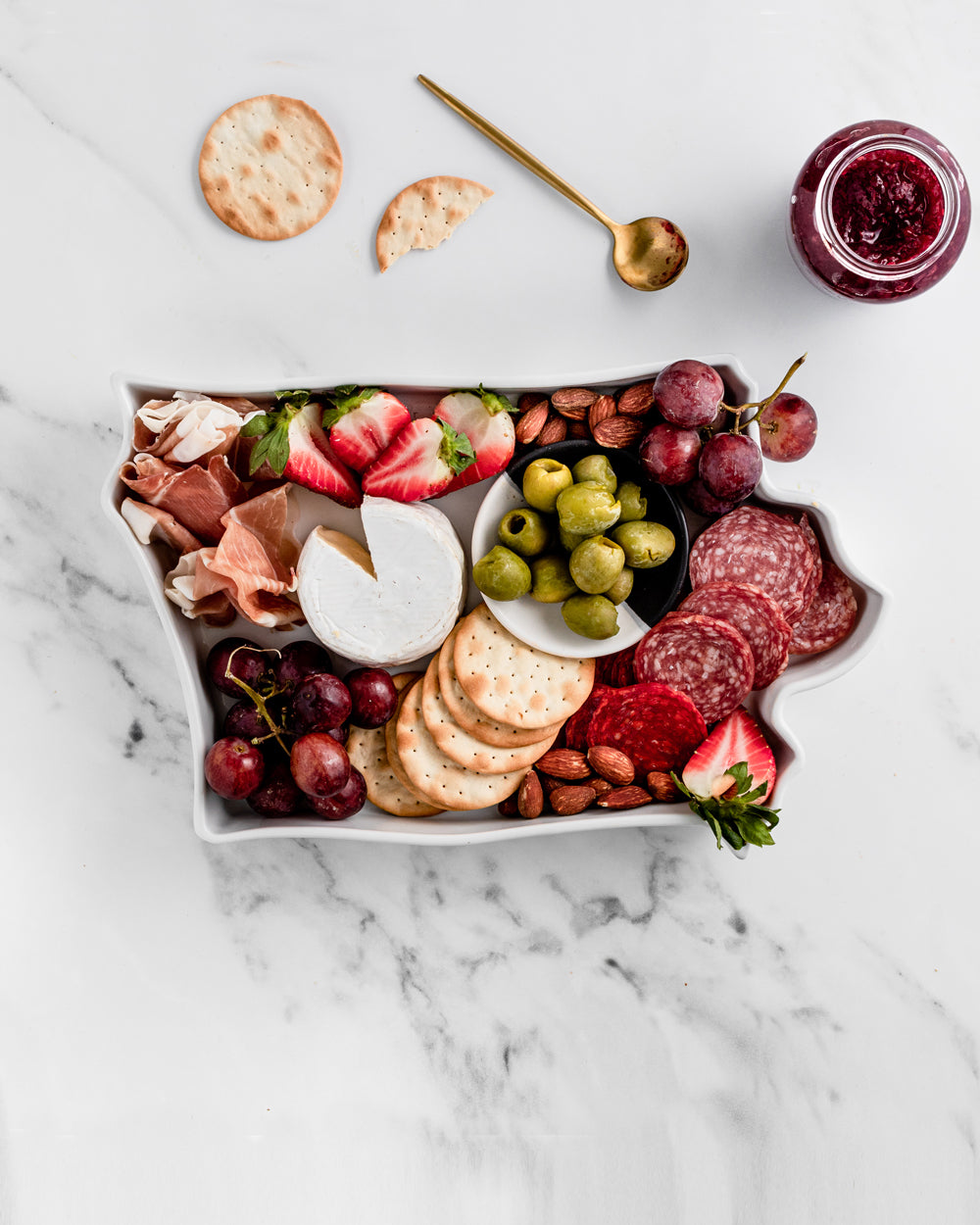 charcuterie board with cheese and cured meats in a Iowa shaped serving tray platter dish