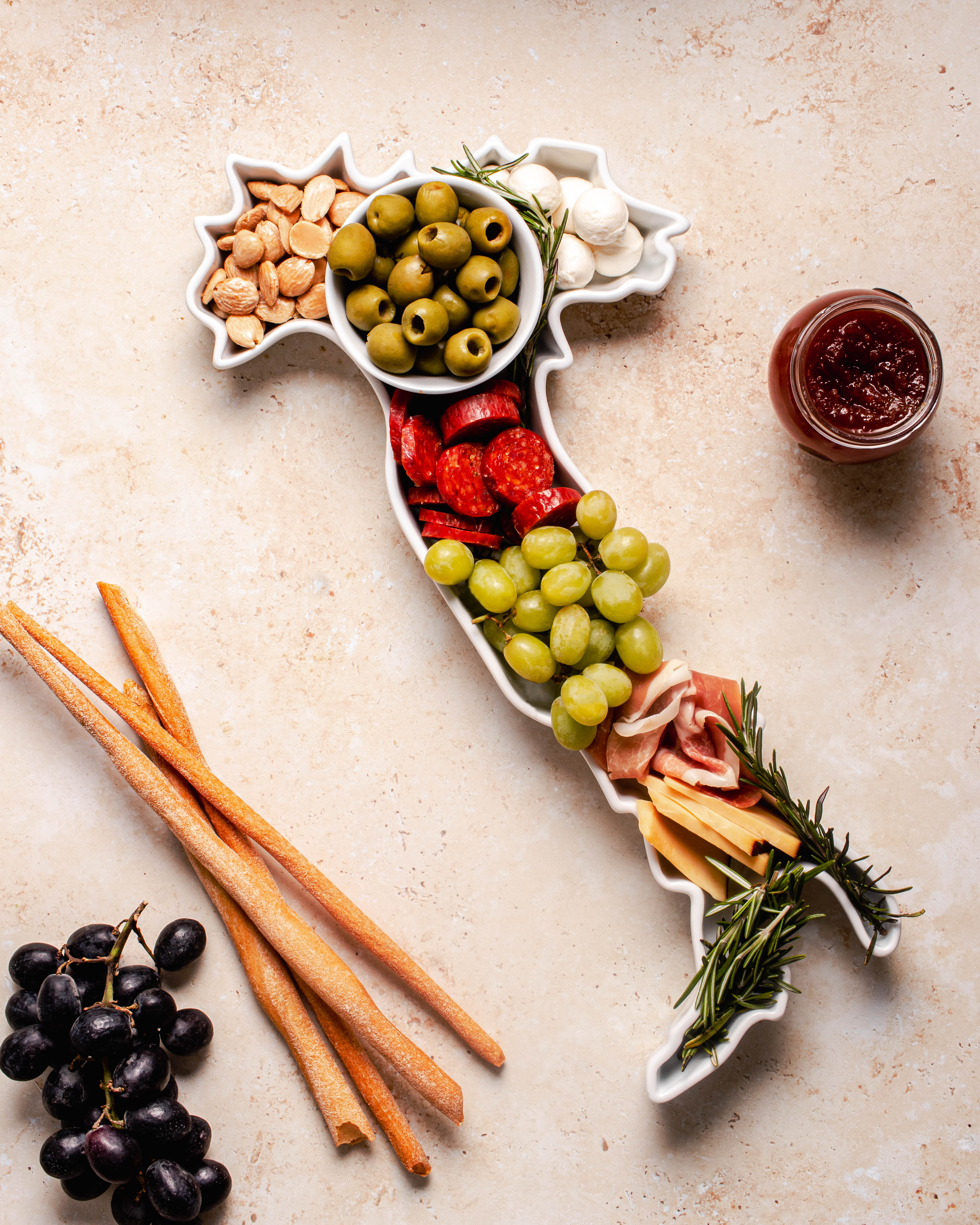 charcuterie board with cheese and cured meats in a Italy shaped serving tray platter dish