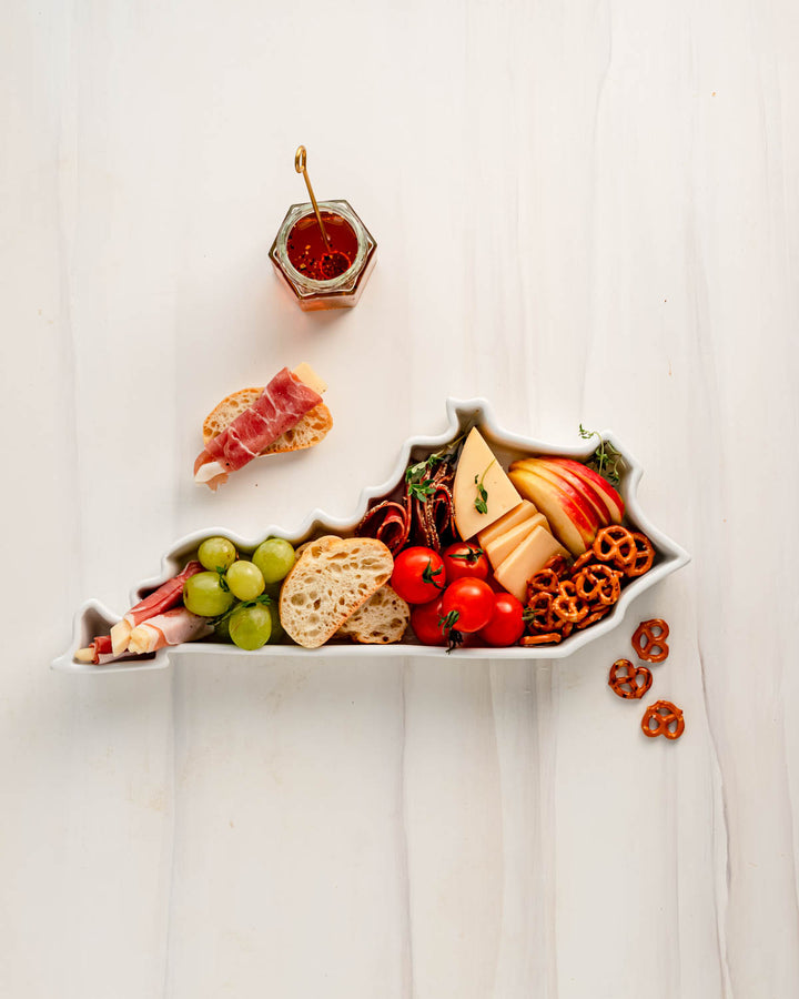 charcuterie board with cheese and cured meats in a Kentucky shaped serving tray platter dish