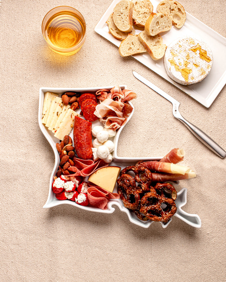 charcuterie board with cheese and cured meats in a Louisiana shaped serving tray platter dish