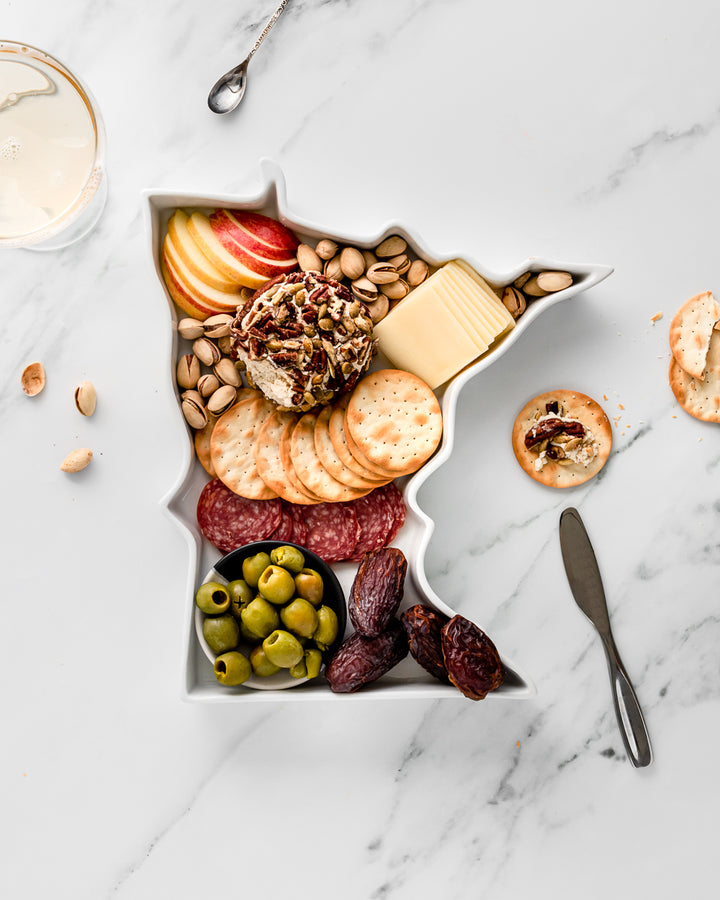 charcuterie board with cheese and cured meats in a Minnesota shaped serving tray platter dish