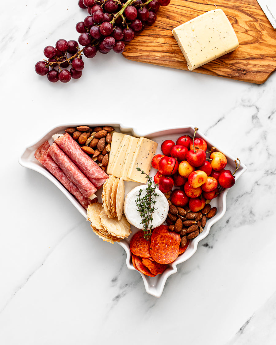 charcuterie board with cheese and cured meats in a South Carolina shaped serving tray platter dish