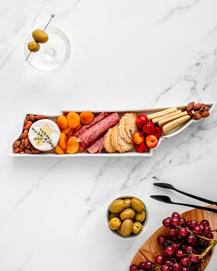 charcuterie board with cheese and cured meats in a Tennessee shaped serving tray platter dish