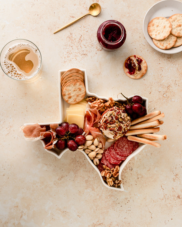 charcuterie board with cheese and cured meats in a Texas shaped serving tray platter dish